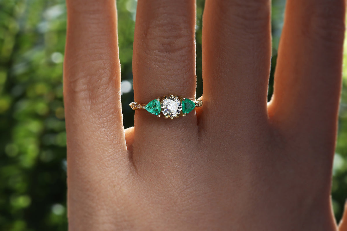 Diamond solitaire with emerald side stones hotsell